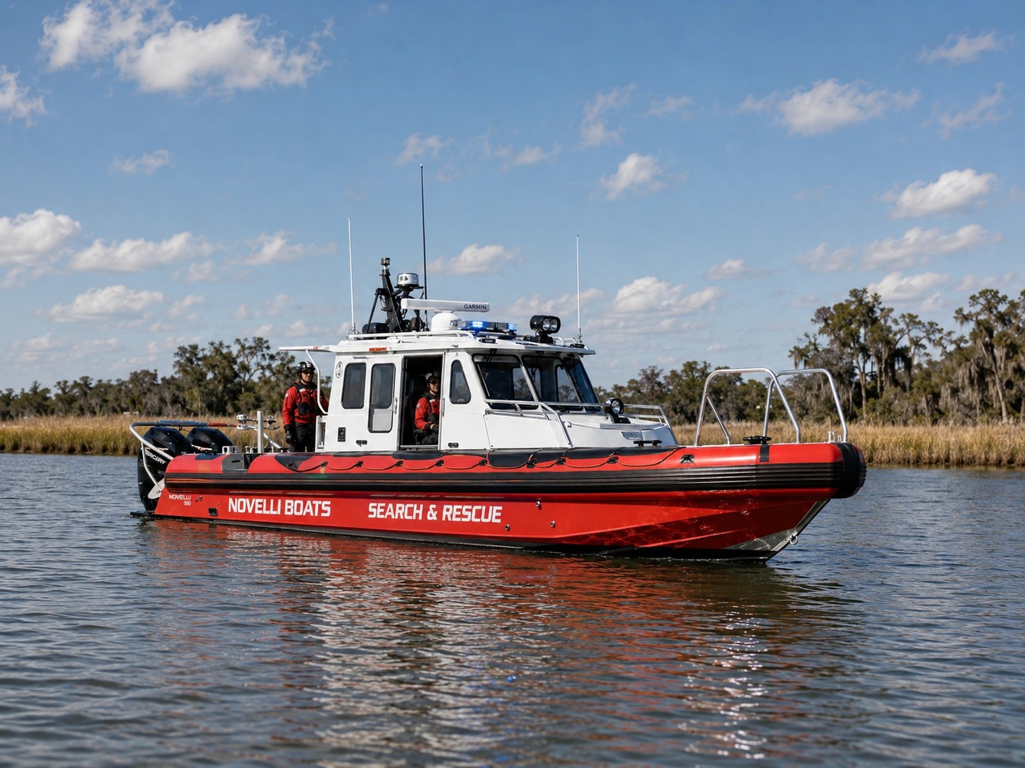 Novielli Guardian 349 SAR aluminum search and rescue boat in red and white livery with twin Mercury outboards on calm coastal water.